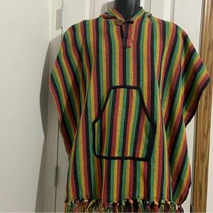Red, green, yellow and black 100% hard cotton fringed hem Pancho. Size: Free.